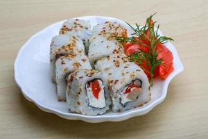 California roll on the plate and wooden background photo