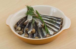 Salted anchovy on wood photo