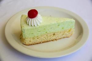 Pistachio cheesecake on white background photo