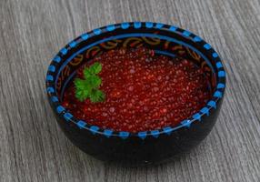 Red caviar on wood photo