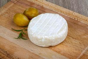 Brie cheese on wood photo