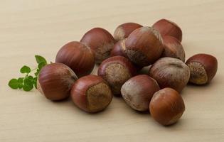 Hazelnut heap on wood photo