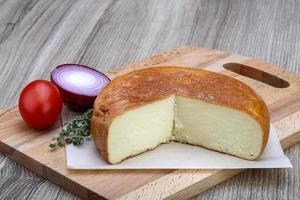 Suluguni cheese on wood photo