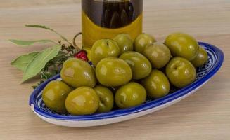 Green olives on wood photo