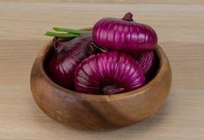 Violet onion on wood photo
