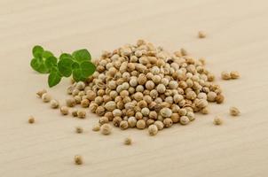 Coriander seeds on wood photo