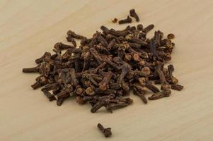 Clove seeds on wooden background photo