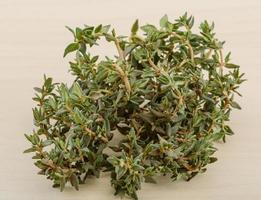 Thyme on wooden background photo