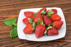 Fresh strawberry on wood photo