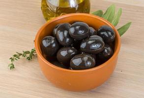 Black olives on wood photo