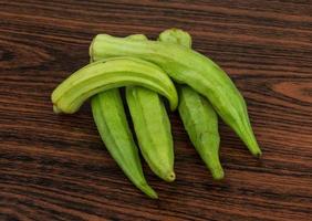 Okra vegetables on wood photo