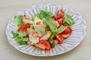 Caesar salad on wood photo