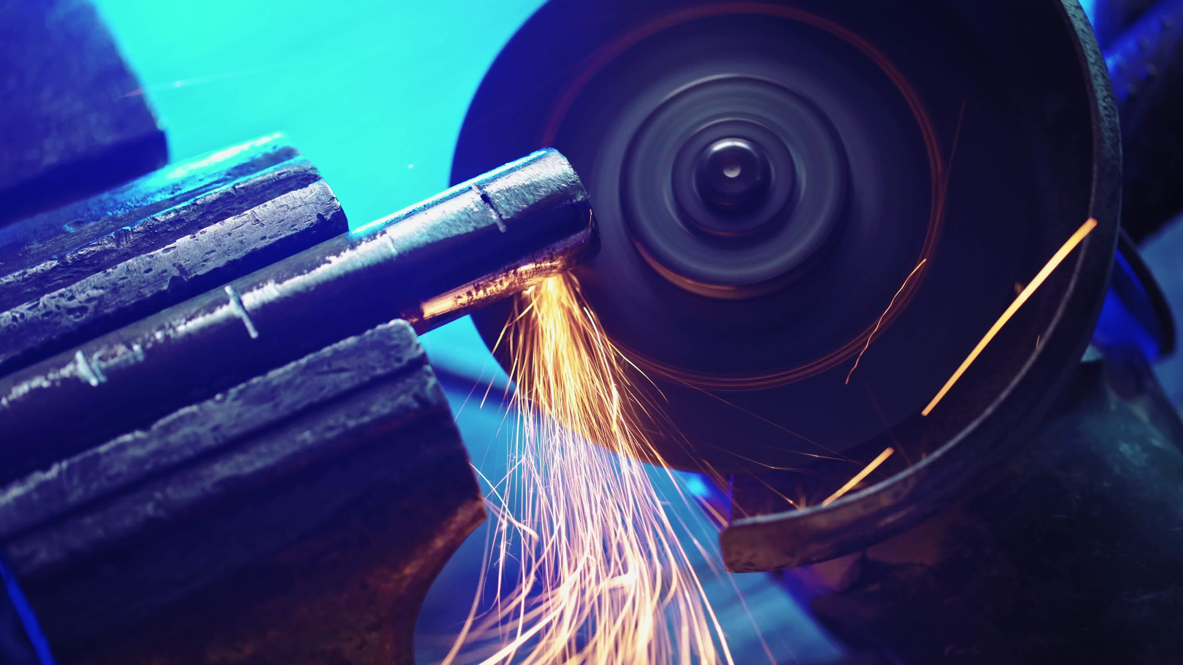 Professional Mechanic Cuts Off Metal Pipe with a Grinder. Man Works