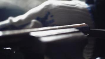 Rasp File Held in Gloved Hands is Used to Smooth the Rough Edges on a Silver Metal Pipe Being Held in a Vice. Sharpening Metal. Close Up. Unrecognizable Person. High quality 4k footage video