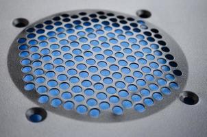 Close-up, shallow focus of a meshed style cooling panel used on a main frame computer. The circular holes aid active venting of hot air within the computer photo