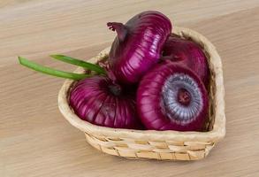 Violet onion on wood photo