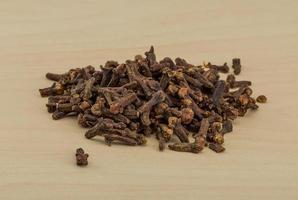 Clove seeds on wooden background photo