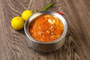 Butter chicken on wood photo