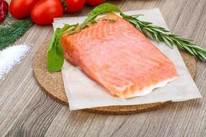 Salted salmon on wooden board and wooden background photo