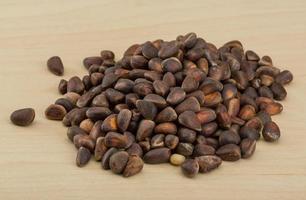 Cedar nut on wooden background photo