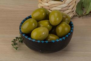 Green olives on wood photo