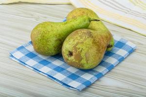 Ripe pears on wood photo