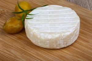 Brie cheese on wood photo