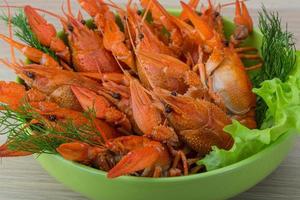 Boiled crayfish on wood photo