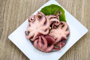 Marinated octopus on wood photo