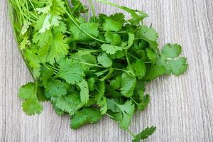 Coriander leaves on wood photo