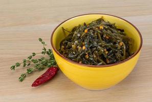 Laminaria salad on wood photo