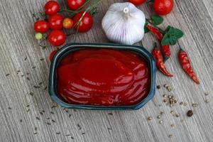 Tomato ketchup on wood photo