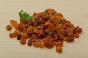 Raisin heap on wood photo