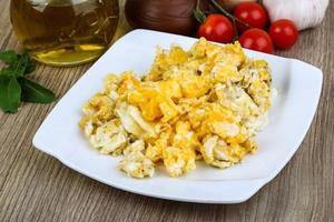 Scrambled eggs on wood photo