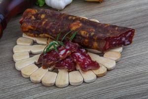 Salami sausage on wood photo