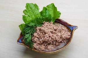 Cannded runa in a bowl on wooden background photo