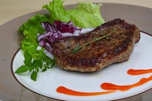 Beefsteak on plate photo