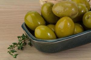 Green olives on wood photo