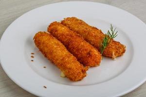 Fried cheese on wood photo