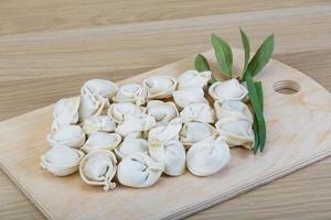 Raw dumplings on wood photo