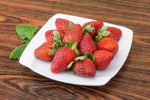 Fresh strawberry on wood photo