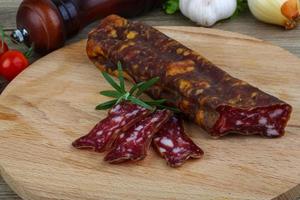 Salami sausage on wood photo