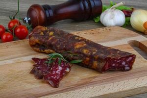 Salami sausage on wood photo