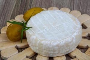 Brie cheese on wood photo