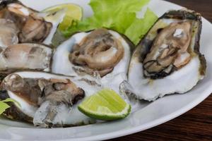 Fresh oyster on wood photo