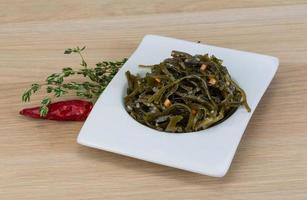 Laminaria salad on wood photo