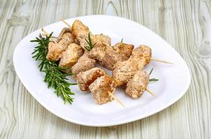 Chicken skewers on plate photo