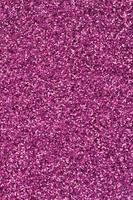 Pink decorative sequins. Background image with shiny bokeh lights from small elements photo