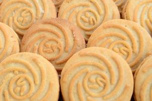 Close-up of a large number of round cookies with coconut filling photo