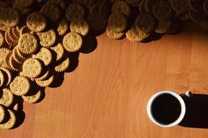 Small coffee cup and salted cracker photo